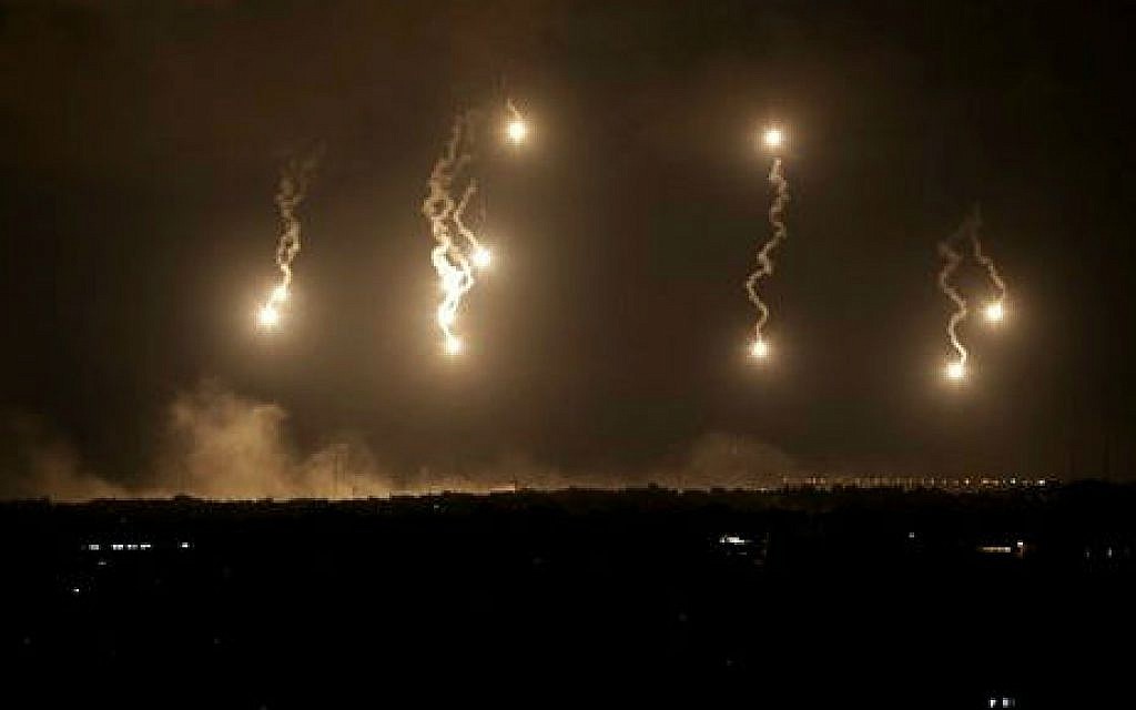 Israeli forces' flares light up the night sky in the northern Gaza Strip, early Saturday, July 19, 2014 (photo credit: AP/Adel Hana)