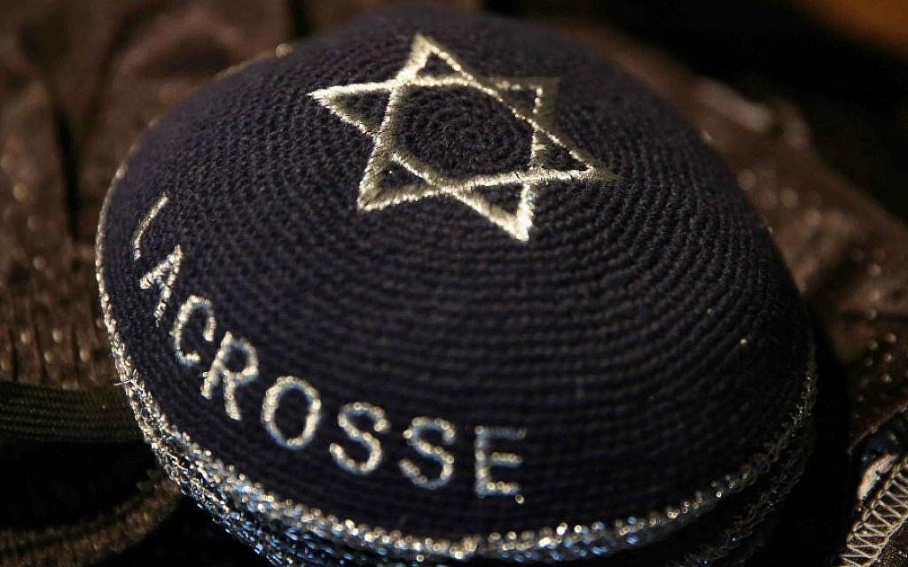 A stack of traditional Jewish skullcaps bear the words 'Israel Lacrosse,' part of the Israeli Lacrosse team's gear, Commerce City, Colorado,  July 15, 2014. (photo credit: AP/Brennan Linsley)