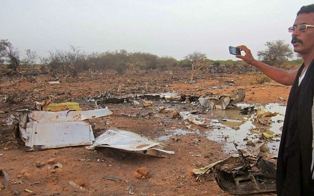 A man at the site of the Air Algerie plane crash in Mali,  Friday, July 25, 2014. (photo credit: AP/Burkina Faso Military)