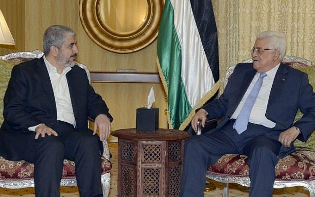 A handout picture released by the Palestinian Authority president's office shows Mahmoud Abbas (right) in a meeting with the head of the political bureau of Hamas, Khaled Mashaal, in Doha, on July 20, 2014. (AFP/PPO/Thaer Ghanem)