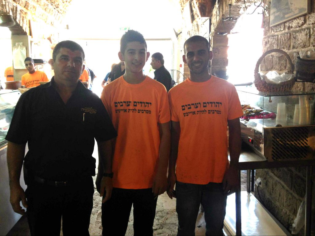 Hani Harawi, the long-time manager of Aboulefia, a family-owned restaurant and bakery, whose staff are wearing shirts stating their commitment to coexistence in Jaffa (photo credit: Jessica Steinberg/Times of Israel)