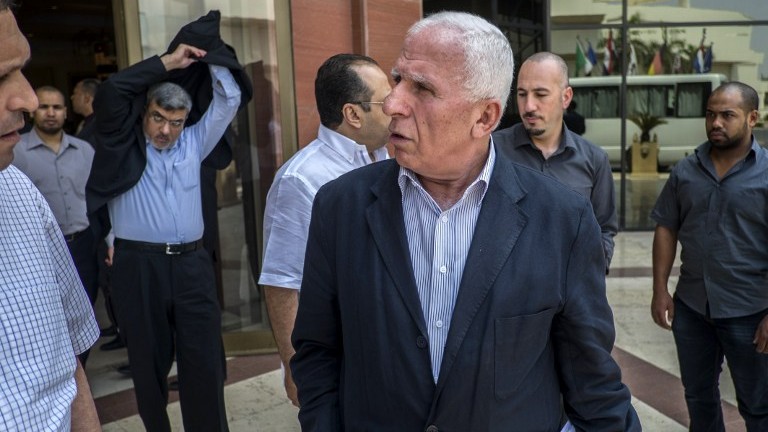 Palestinian Fatah delegation chief Azzam al-Ahmed, center, and members of the delegation leave the hotel where the negotiations are taking place with Egyptian intelligence mediators aimed at brokering an end to the Gaza conflict on August 12, 2014 in the Egyptian capital, Cairo. (photo credit: AFP/KHALED DESOUKI)