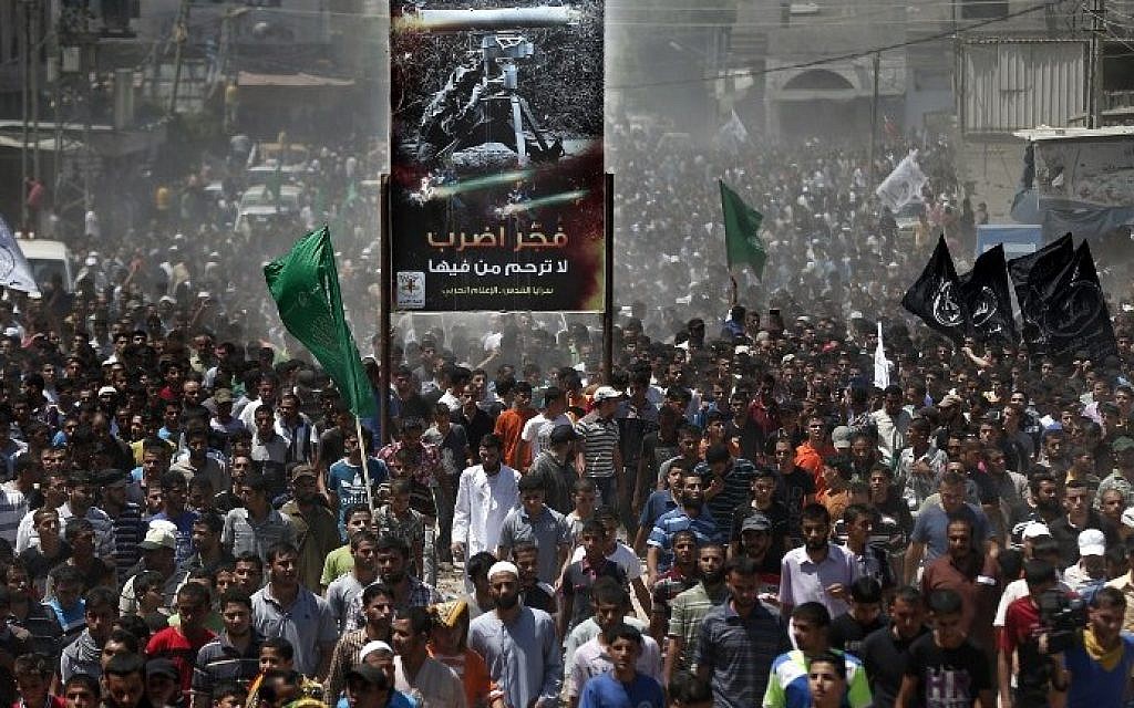 Thousands of Palestinian Hamas supporters follow the body three of Hamas senior commanders during their funeral in Rafah in the south of the Gaza Strip, on August 21, 2014.(photo credit: AFP Photo/Thomas Coex)
