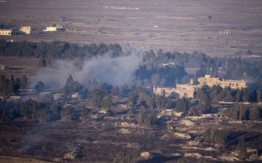 Smoke rises from the Syrian village of Quneitra, as seen from the Israeli Golan Heights, on August 27, 2014 (photo credit: AFP/JACK GUEZ)