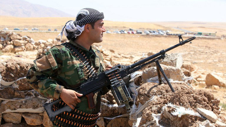 An Iraqi Kurdish peshmerga fighter takes up position in the town of Bashiqa, 13 kilometers northeast of Mosul, on August 12, 2014. (photo credit: AFP/Ahmad al-Rubaye) 