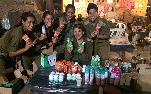 IDF soldiers hold Garnier care packages.  (StandWithUs)