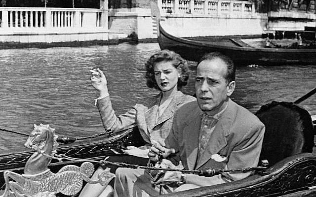Humphrey Bogart, tough guy of the films, and his equally famous wife, Lauren Bacall, take things easy as they glide through Venice in a gondola during a visit to the Italian city of canals, May 31, 1951. (photo credit: AP Photo)