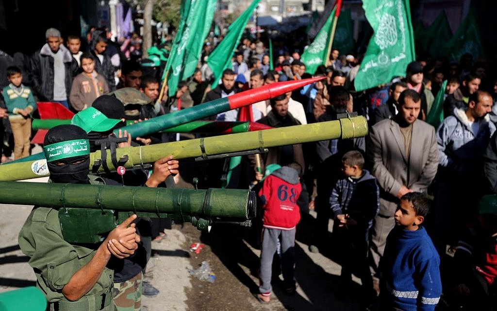 Members of the Izz Al-Din Al Qassam Brigades, the military wing of Hamas, attend a demonstration at Nuseirat Refugee Camp in the central Gaza Strip against resuming peace talks with Israel, January 24, 2014. (photo credit: AP/Hatem Moussa)