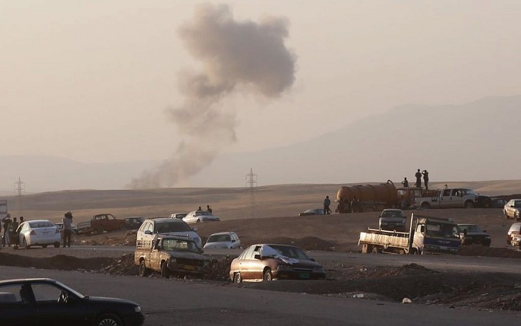 Smoke rises after airstrikes targeting Islamic State militants near the Khazer checkpoint outside of the city of Irbil in northern Iraq, Friday, Aug. 8, 2014.  (Photo credit: AP/ Khalid Mohammed)