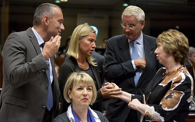 European Union High Representative Catherine Ashton, right, speaks with then Italian Foreign Minister Federica Mogherini, second left, and Swedish Foreign Minister Carl Bildt, second right, during a round table meeting of EU foreign ministers at the EU Council building in Brussels on Friday, Aug. 15, 2014. (photo credit: AP Photo/Virginia Mayo)