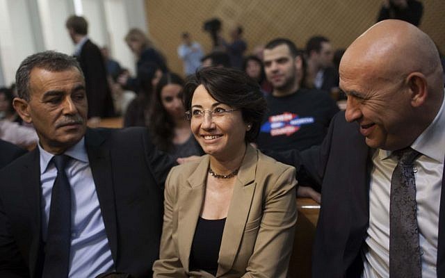 MK Hanin Zoabi (c) and Parliament member Jamal Zahalka (L) at the High Court of Justice courtroom for Zoabi's 2012 appeal against disqualification for upcoming elections due to her participation in the Turkish IHH flotilla (May 2010) aboard the Mavi Marmara. (photo credit: Yonatan Sindel/Flash90 )