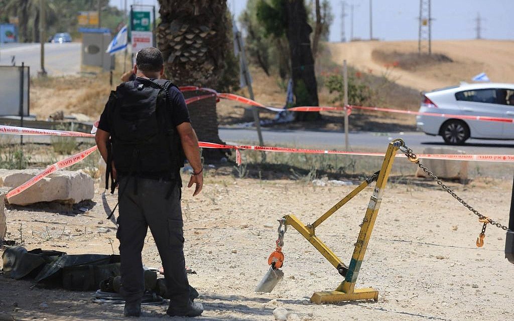Police sappers inspect a part of a rocket that exploded inside Israel near the border with the Gaza Strip on August 8, 2014.  (photo credit: Edi Israel/Flash90)