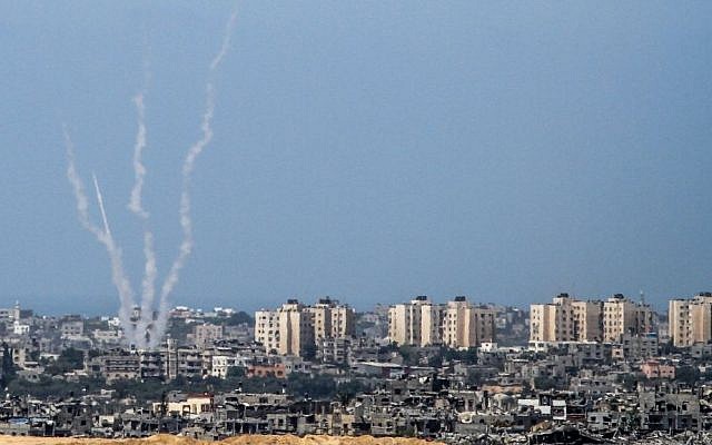 Illustrative: The Israel-Gaza border, from the Israeli side, with rockets being fired by Palestinian terrorists from the Gaza Strip into Israel, August 20, 2014. (Albert Sadikov/Flash90)