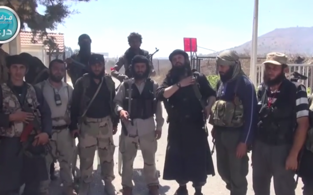 Al-Nusra Front fighters standing near the Quneitra crossing between Israel and Syria. (screen capture: YouTube)