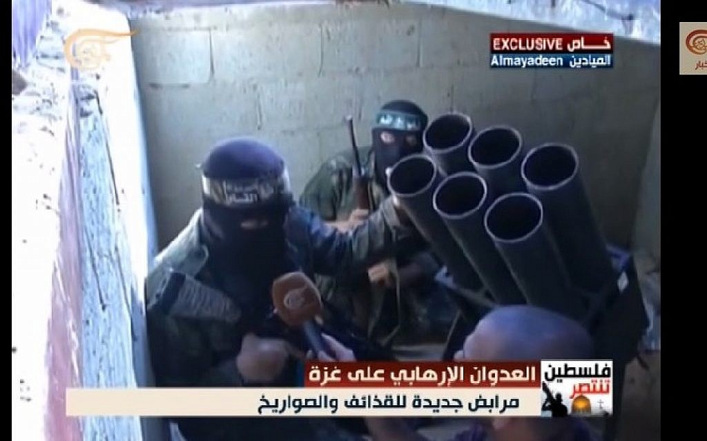 In footage captured by al-Mayadeen, Hamas Izz ad-Din al-Qassam Brigades fighters are seen preparing rockets to launch against Israel in a tunnel underneath the Gaza Strip, August 2014. (screen capture, YouTube)