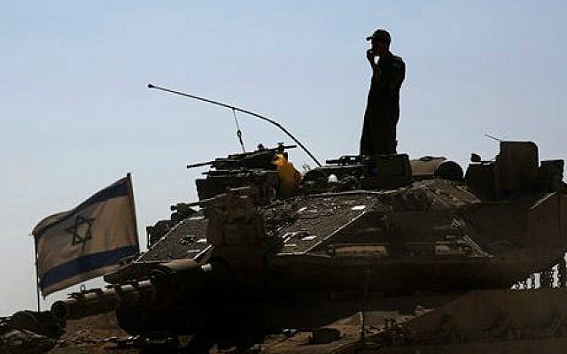 An Israeli soldier standing on top of a tank in a staging area near the Israel Gaza border, Saturday, August 2, 2014 (photo: AP/Tsafrir Abayov)