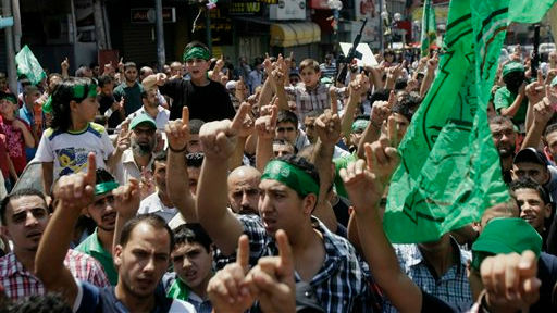 Hamas supporters shout slogans to support people in Gaza and Palestinian negotiators in Cairo, Egypt, during a demonstration in the West Bank city of Nablus on Friday, Aug. 15, 2014 (photo credit: AP Photo/Nasser Ishtayeh) 