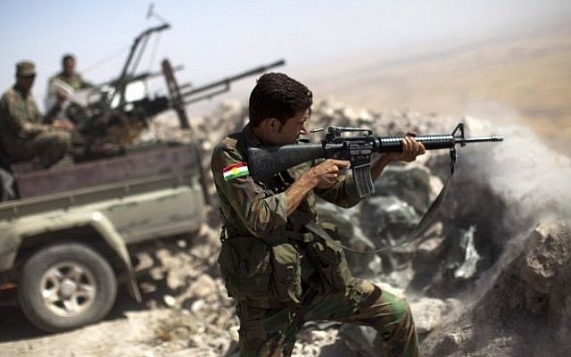 Illustrative photo of an Iraqi Kurdish peshmerga fighter firing at Islamic State (IS) positions, on September 9, 2014. (photo credit: AFP/JM Lopez)