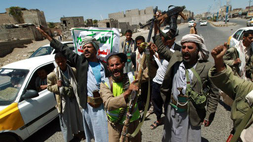 Armed Yemeni Shiite Huthi anti-government rebels shout slogans as they man a checkpoint erected after the Huthi group seized northern districts of the capital Sanaa on September 21, 2014. (photo credit: AFP/MOHAMMED HUWAIS)