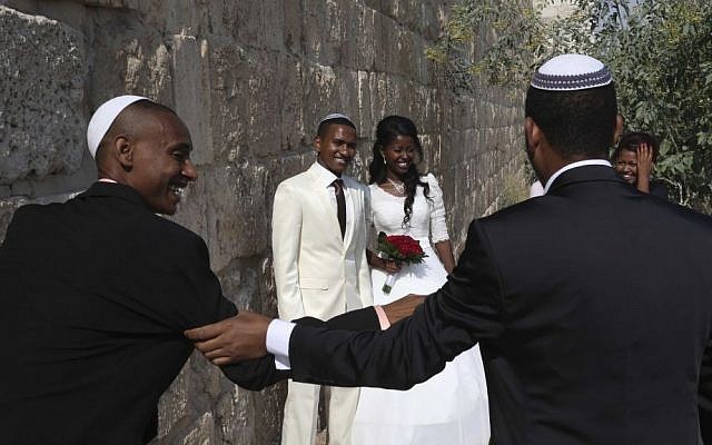 Illustrative photo of an Ethiopian Jewish couple seen posing for a wedding photographer next to the Old City Walls in Jerusalem. (photo credit: Nati Shohat/Flash90)