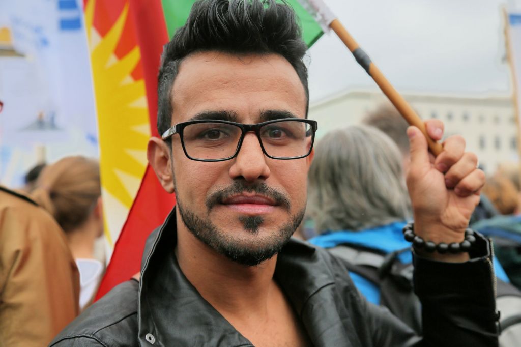 Mulsim Benno Bahman from Erbil in Iraqi Kurdistan carried a large Kurdish flag at the September 14, 2014 rally against anti-Semitism in Berlin. (Micki Weinberg/The Times of Israel)