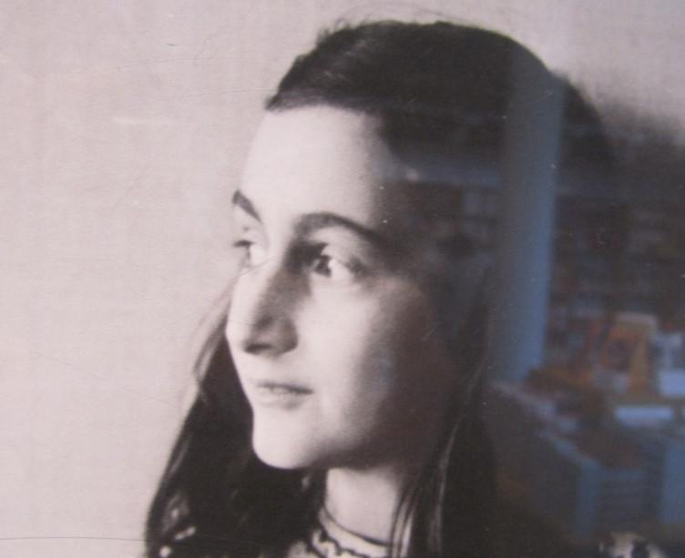 Photograph taken in the Anne Frank House book shop with her image and translated copies of the diary in the background (photo credit: Matt Lebovic)