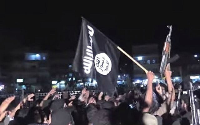 Supporters of the Islamic State wave guns and flags at a rally in Raqqa, Syria (photo credit: YouTube screen cap/Vice)