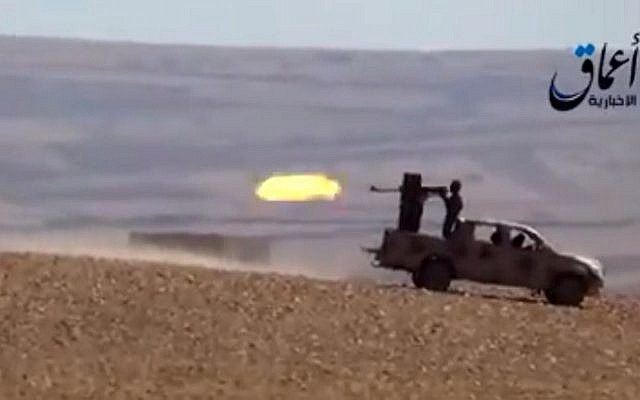 Illustrative screen capture from a YouTube video allegedly shows Islamic State group fighters firing from an armed vehicle (AFP/HO/AAMAQ NEWS AGENCY)