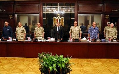 Egypt's President Abdel Fattah el-Sissi is flanked by members of the high military council as they observe a minute of silence for the soldiers who were killed in the Sinai Peninsula. October 25, 2014 (Photo credit: Egyptian Presidency/AFP)