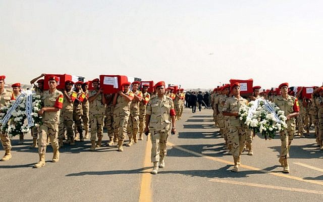 A handout picture released on October 25, 2014 by the Egyptian Presidency, shows the funeral for 30 solders killed the day before in the Sinai, at the Almaza military airbase in Cairo. (photo credit: AFP/ HO/EGYPTIAN PRESIDENCY)