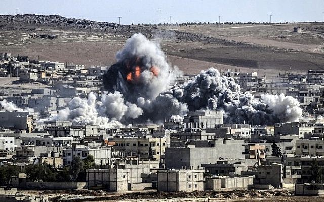 Smoke and flames billow following an explosion in the Syrian town of Kobani, October 22, 2014.  (photo credit: AFP/STRINGER)