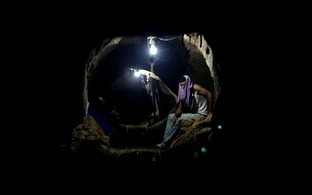 In this Monday, September 30, 2013 file photo, a Palestinian worker rests inside a smuggling tunnel in Rafah, on the border between Egypt and the southern Gaza Strip. (AP/Hatem Moussa)
