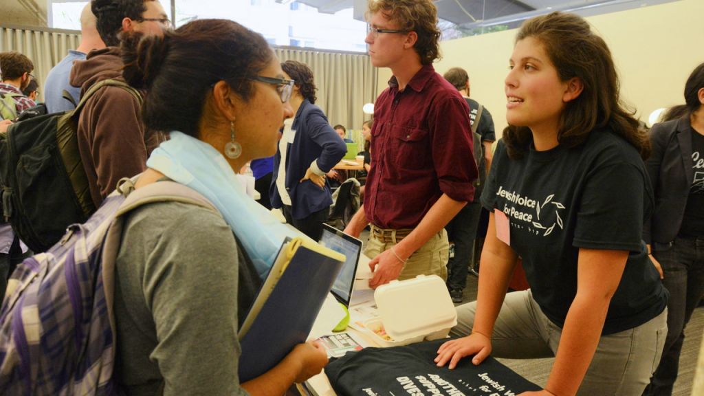 A representative of Jewish Voice for Peace speaking with a student at the Open Hillel conference at Harvard University, October 12, 2014. (Gili Getz/JTA) 