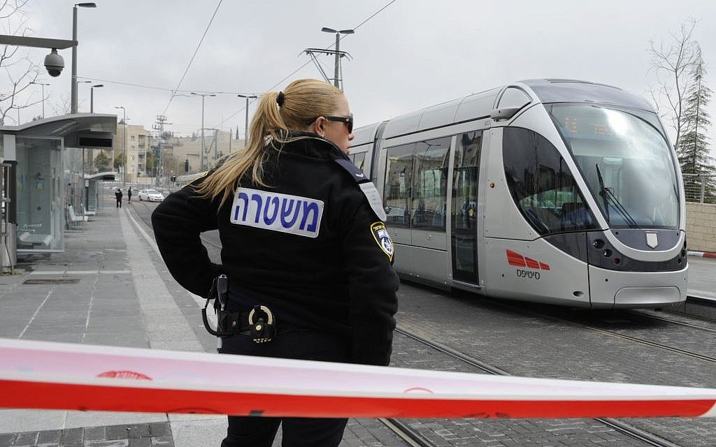 An Israeli police officer stands guard at the scene of a stabbing attack on the light rail in Pisgat Zeev in 2012. (photo credit: Uri Lenz/FLASH90)