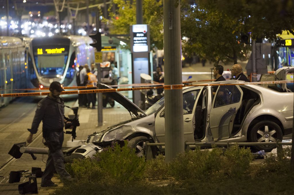 Police and rescue personnel at the scene where a baby was killed and several people were injured as a  Palestinian drove his car into the Jerusalem light rail station, by Ammunition Hill October 22, 2014. (Photo credit: Yonatan Sindel/Flash90)