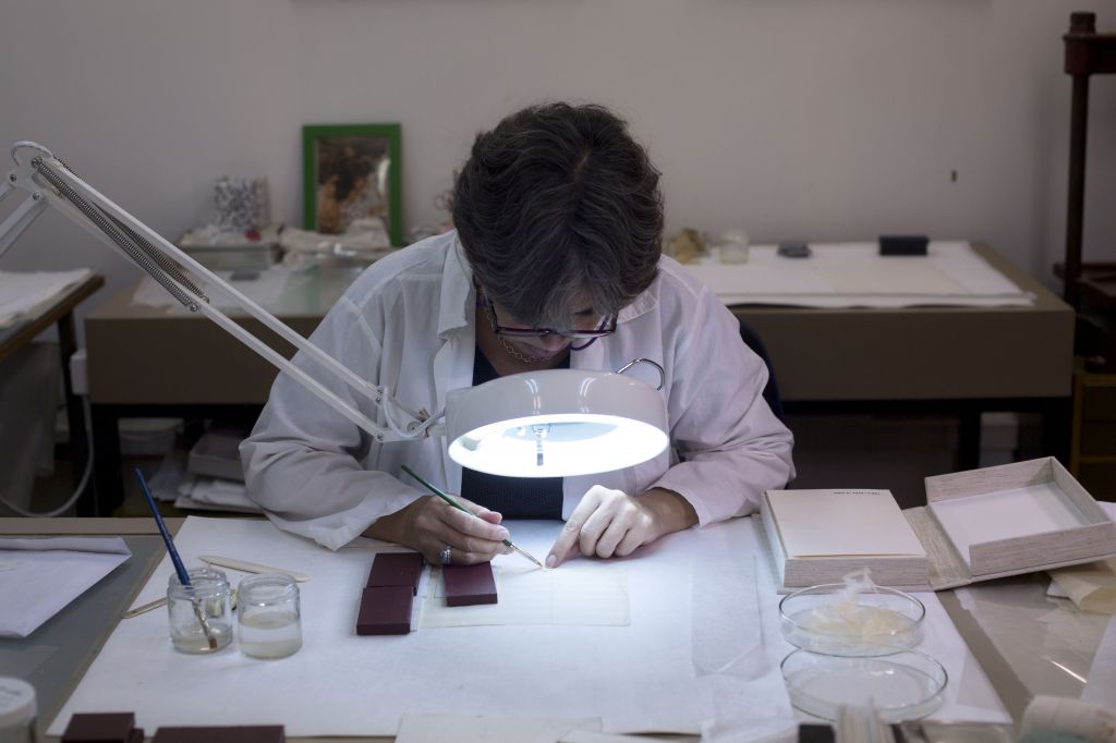A conservation expert repairs a manuscript at Israel’s National Library in Jerusalem, October 5, 2014. (photo credit: AP Photo/Sebastian Scheiner)