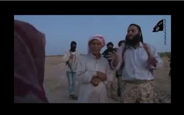 Screen capture from an alleged Islamic State video showing a father (C) stoning his own shrouded daughter (L) to death for adultery, October 21, 2014. (screen capture: YouTube/hasrr1)