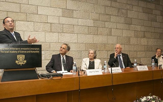Education Shai Piron (left) speaks at Israel Academy of Sciences and Humanity conference in Jerusalem, as others, including President Reuven Rivlin (right), look on. October 19, 2014. (photo credit: Michal Fattal)