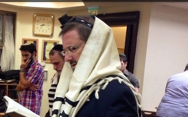 Yesh Atid MK Dov Lipman attends morning prayers at the Kehilat Bnei Torah synagogue in Har Nof, Jerusalem, on November 19, 2014. (photo credit: Courtesy)