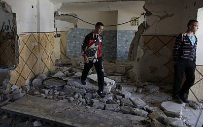 A relative of Abdelrahman Shaludi, a Palestinian who killed two Israelis with his car last month, walks inside his family home after it was razed by Israeli authorities in the East Jerusalem neighborhood of Silwan, November 19, 2014. (photo credit: AFP/Ahmad Gharabli)