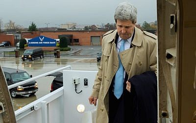 US Secretary of State John Kerry boards his aircraft in the rain at Andrews Air Force Base in suburban Washington on November 17, 2014, en route to London, United Kingdom, and Vienna, Austria, for talks about the future of Iran's nuclear program and other international issues. (photo credit: State Department/ Public Domain)