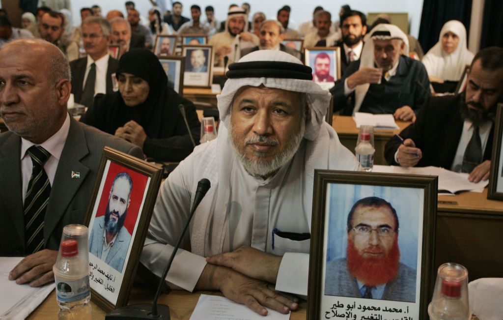 Hamas lawmakers in the Gaza Strip display pictures of deputies detained by Israel during a Palestinian Legislative Council meeting in Gaza City, November 7, 2007 (photo credit: AP/Hatem Moussa)
