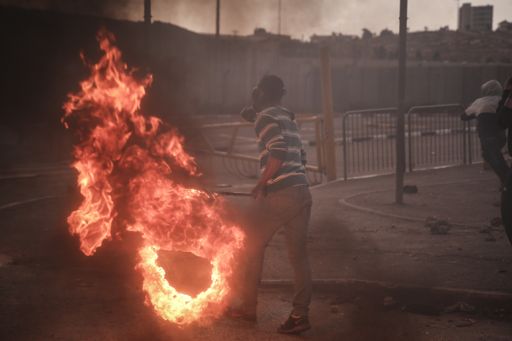 Palestinian youths clash with Israeli Border Police at the entrance to the Shuafat refugee camp on November 5, following a terrorist attack that day in Jerusalem by a resident of the camp. (photo credit: Hadas Parush/FLASH90)