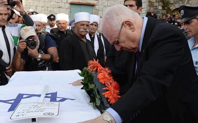 President Reuven Rivlin attends the funeral ceremony of Israeli-Druze policeman, Zidan Saif, in the Druze village of Yenuch-Jat, northern Israel, on November 19, 2014. (photo credit: Mark Neyman/GPO)