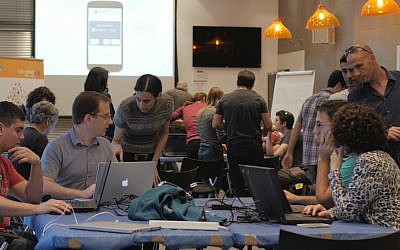 SAP volunteers work to develop the ALS data hack at the Prize4Life hackathon (Photo credit: Courtesy)