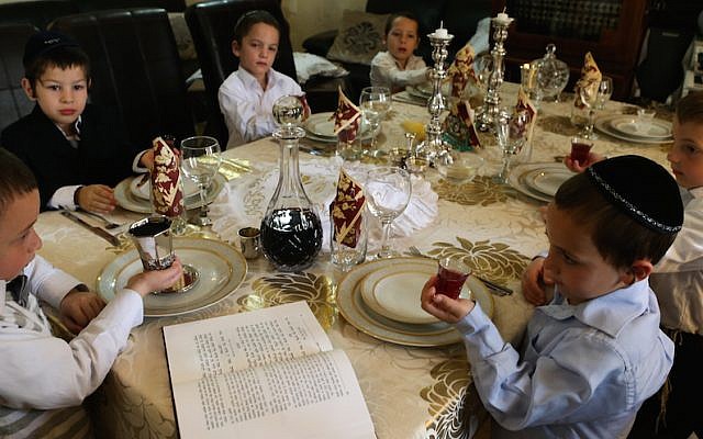 Children make kiddush at a model Passover seder (Nati Shohat/Flash90)