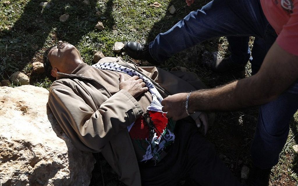 Palestinian official Ziad Abu Ein after a scuffle with Israeli forces during a demonstration in the West Bank on Wednesday, December 10, 2014 (photo credit: AFP/ABBAS MOMANI)