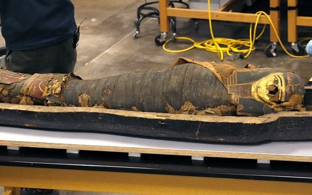 In this photo taken Friday, Dec. 5, 2014, in Chicago, the mummified body of Minirdis, a 14-year-old Egyptian boy lies in his opened coffin after J.P. Brown and his team of curators at the Field Museum opened the coffin for the first time. (photo credit: AP/Charles Rex Arbogast)