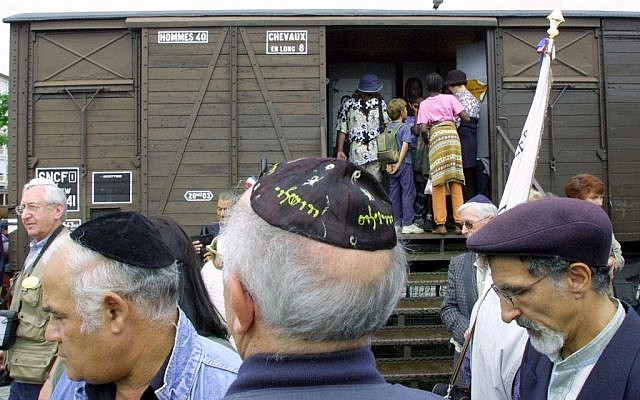 This Monday Aug. 20, 2001, file photo shows French Holocaust survivors gathering at the site of the former Drancy detention camp, north of Paris, France. From Aug. 20, 1941 until the end of World War II, more than 70,000 Jewish men, women and children passed through Drancy on their way to Nazi extermination camps, particularly Auschwitz. (AP Photo/Michel Euler)