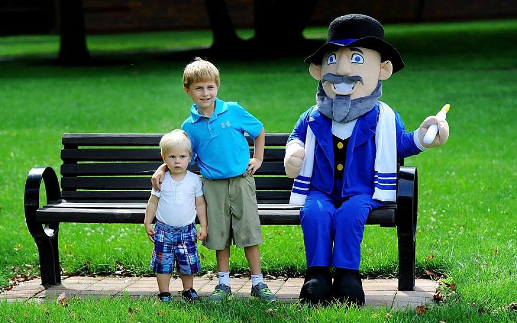 The Hoffman boys pose next to their father's creation, Mensch on a Bench. (courtesy)